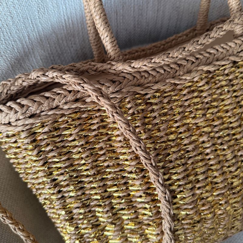 Detalhe do trançado em palha dourada da bolsa Bellisse